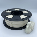 A spool of off-white 3D printing filament mounted on a black plastic reel, with a small white plastic cap or cover attached at the top, shown against a plain light background.
