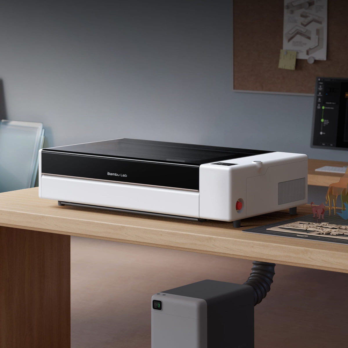 Bambu Lab R1 laser cutter set up on a desk in a home workshop