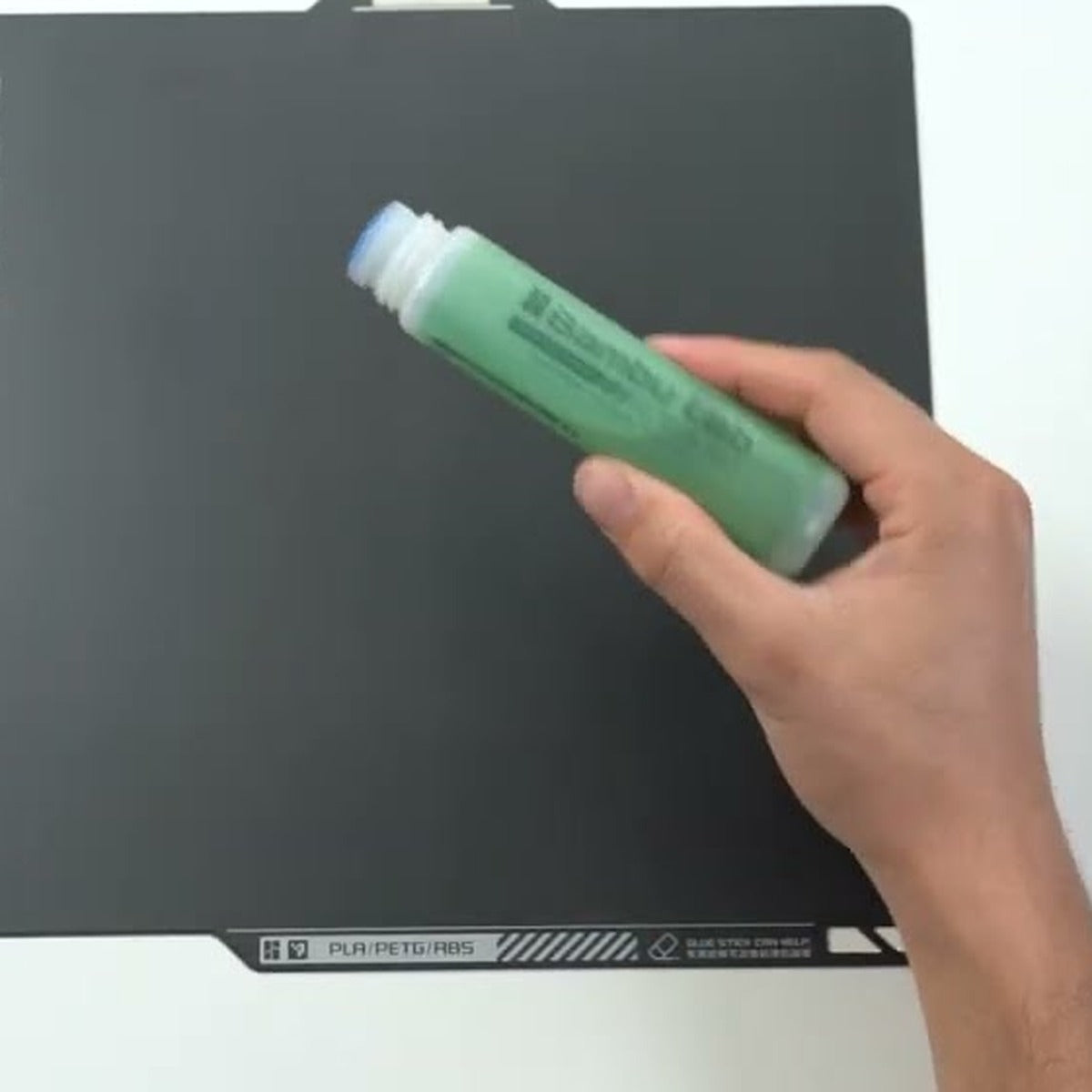 Bambu Lab Liquid Glue applicator tip on a build plate