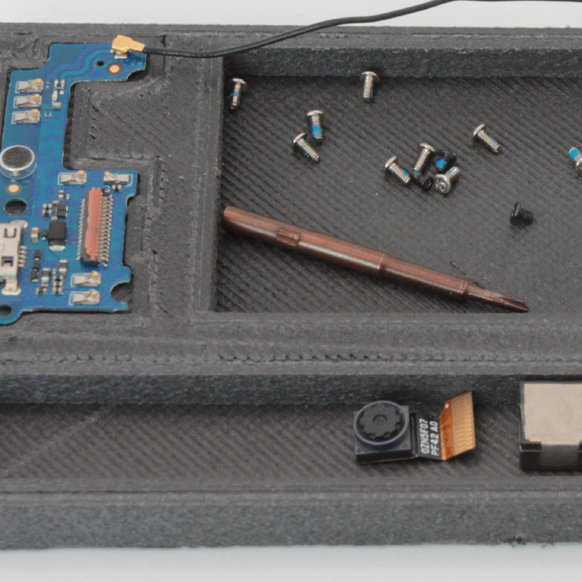 PA6-CF20 printed parts tray holding small screws and a circuit board