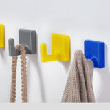 Grey/yellow/blue wall hooks holding braided strap + knit fabric (tough everyday use)