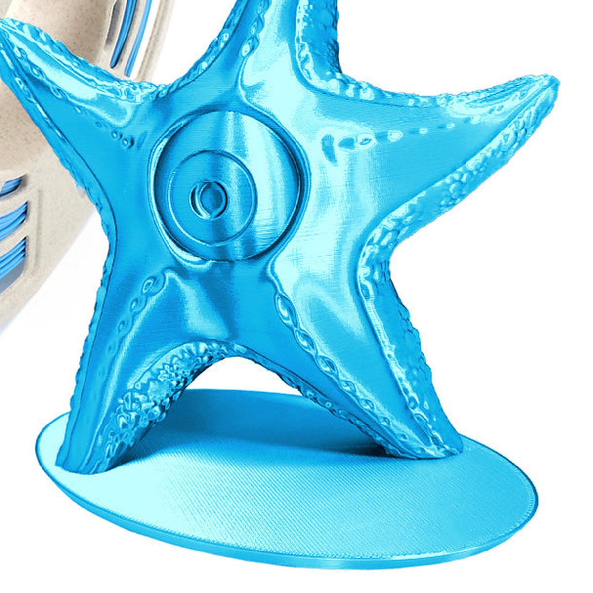 Close-up of RepRapper Tech Silk Blue PLA starfish print with glossy silk sheen and partial matching spool