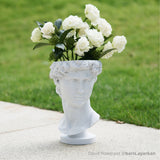 David bust flowerpot printed in marble PLA with white flowers outdoors