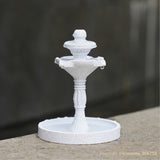 Three-tier fountain in white marble-speckled PLA on a stone ledge outdoors