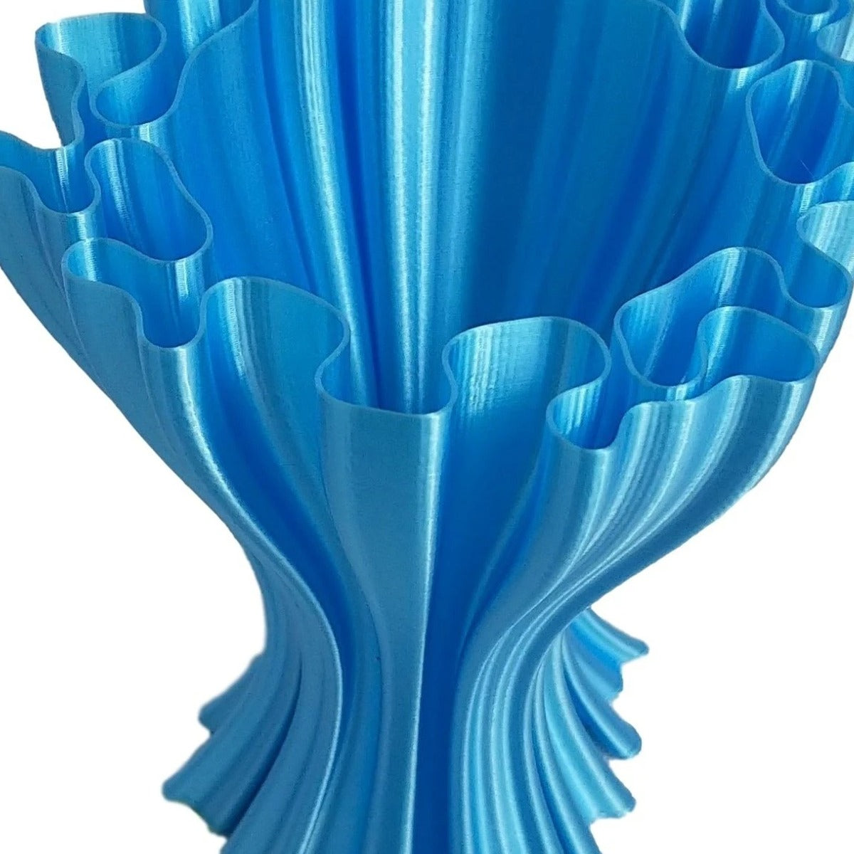 3D-printed ruffled organic vase in cyan/sky-blue RepRapper Tech PLA with satin sheen and visible layer lines on white background