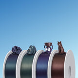 Four Bambu PLA Galaxy spools with a printed model sitting on each one