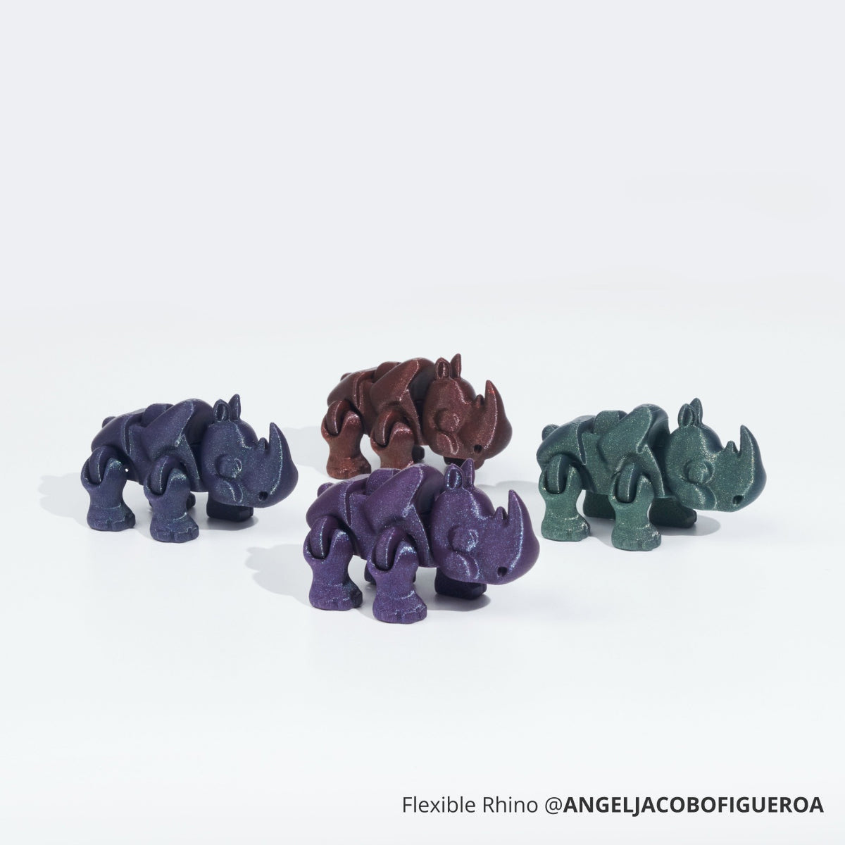 Rhino figures 3D printed in Bambu PLA Galaxy in four shimmering colours