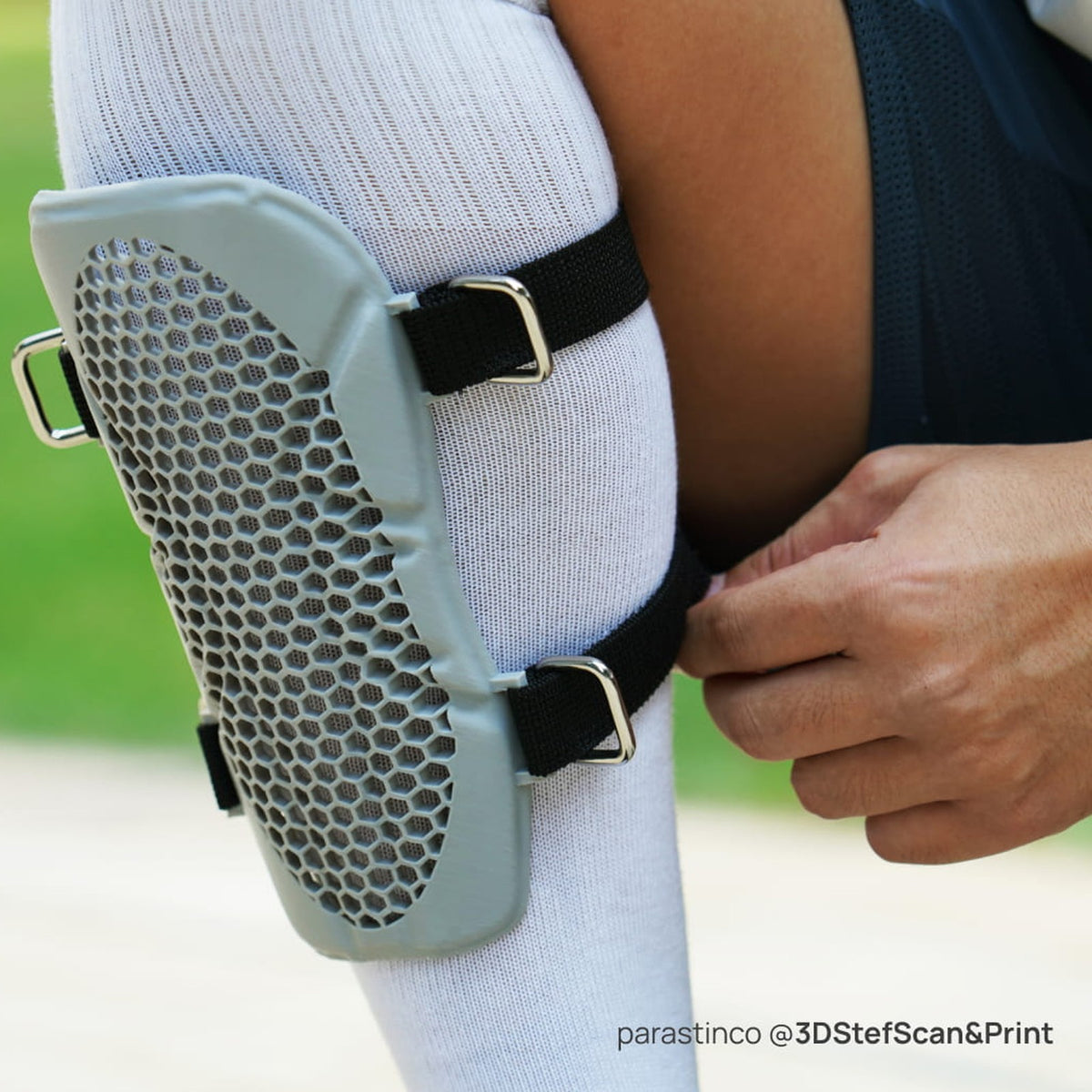 Knee guard 3D printed in grey Bambu PLA Tough+ strapped on a player's leg