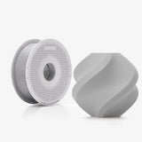 Bambu PLA Tough+ spool next to a grey printed vase