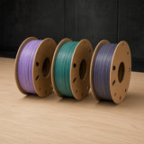 RepRap Warehouse Recycled PLA filament, three colours side by side on cardboard spools